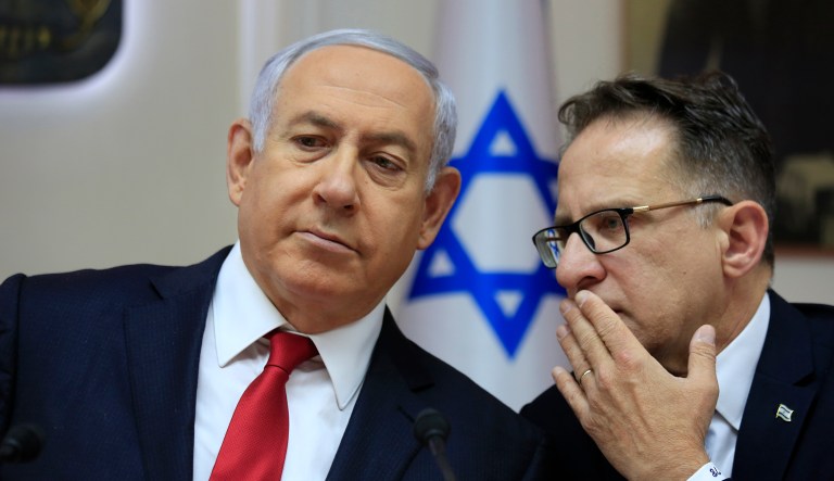 Israeli Prime Minister Benjamin Netanyahu, left, listens to Cabinet Secretary Tzachi Braverman during the weekly cabinet meeting at the Prime Minister's office in Jerusalem, Sunday, May 19, 2019.