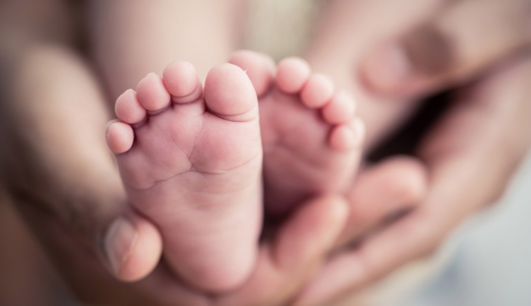 A newborn baby's feet are seen.