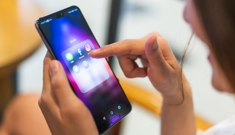 A woman using her phone and social media apps.