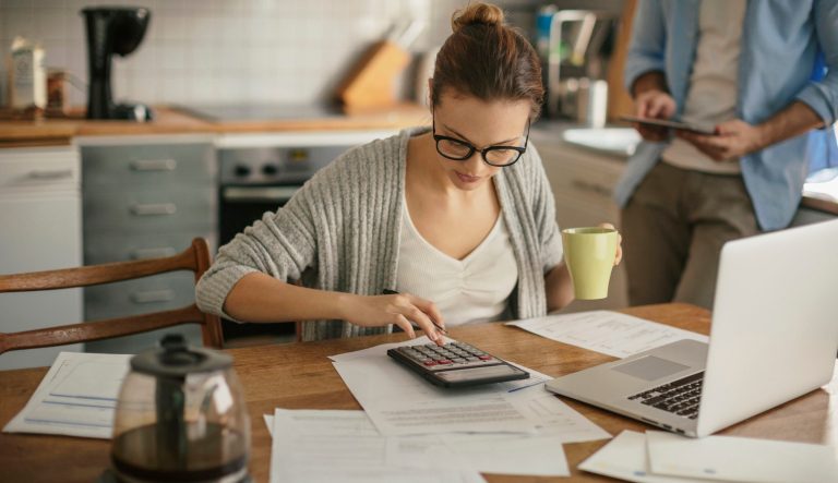 Close up of a young couple doing their bills in the morning.