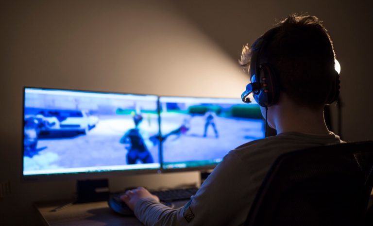 Young boy playing games on a computer at home.