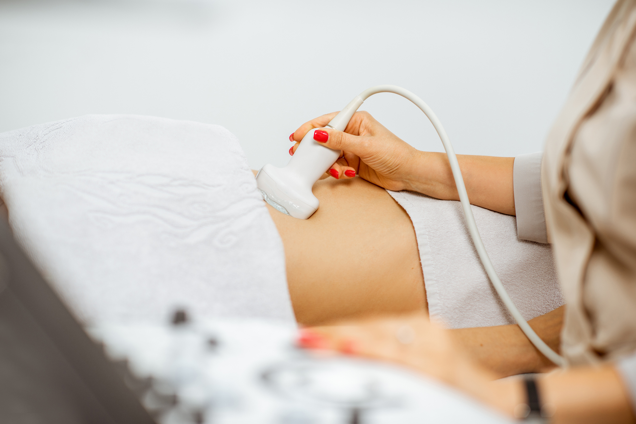 Doctor performs ultrasound examination of a woman