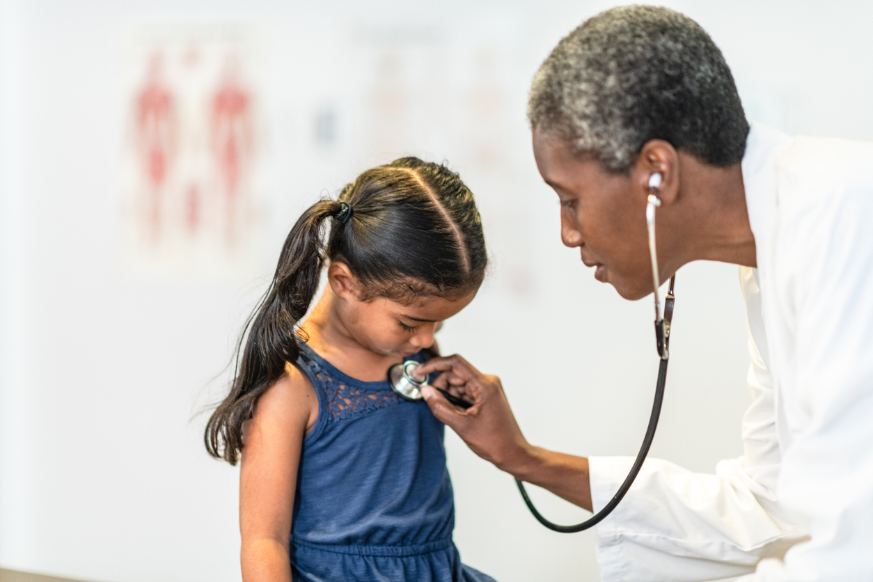 Mother and Daughter Visit Doctor stock photo