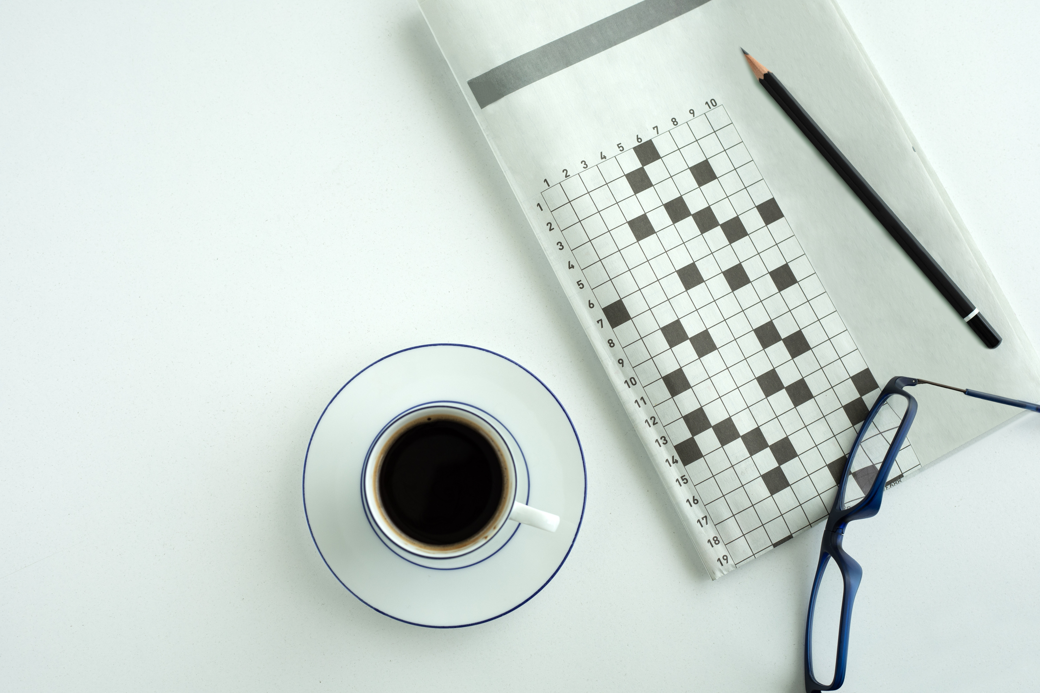 crossword paper with eyeglasses