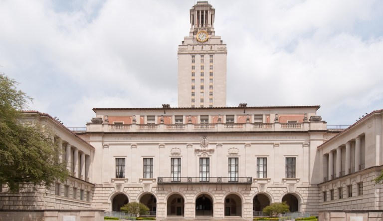 The University of Texas clock tower is seen on a cloudy day.
