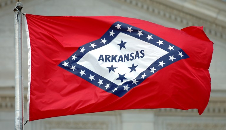 The Arkansas state flag flies near the state capitol building in Little Rock.