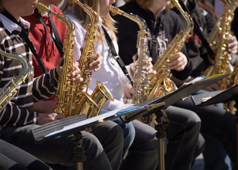 Photos of high school band practice in cramped COVID-19 enclosures draw ire and mockery