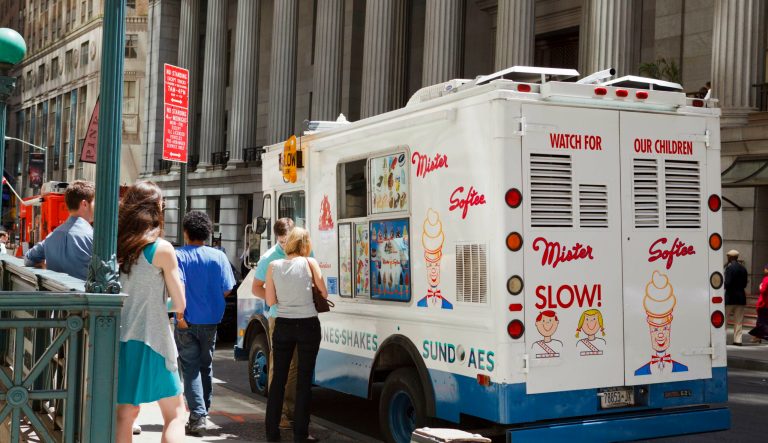 New York, New York â June 2, 2011: People standing by a Mister Softee Ice Cream truck on Wall Street in the Financial District of Lower Manhattan.