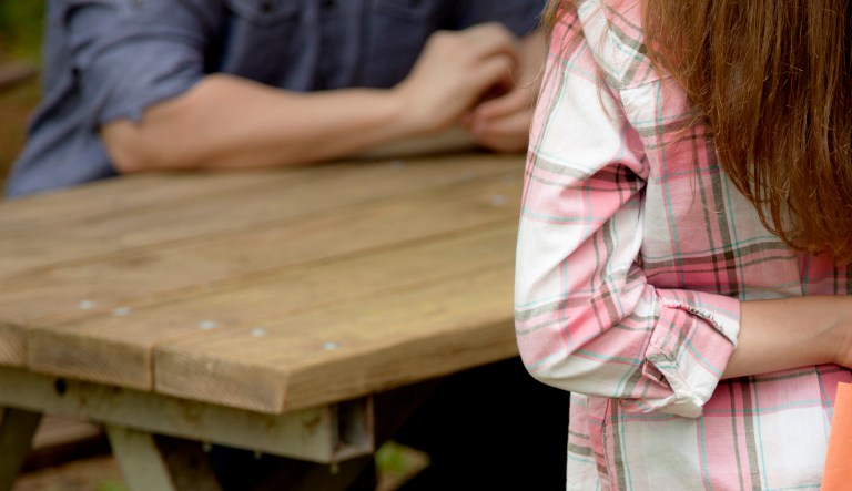 A father is about to receive a homemade card from his daughter.