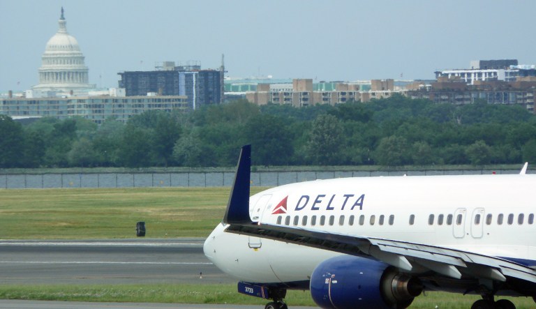 Washington, DC, USA - June 2, 2013: Delta Airlines jet taxiing in front of the US Capital at Ronald Reagan Washington National Airport.