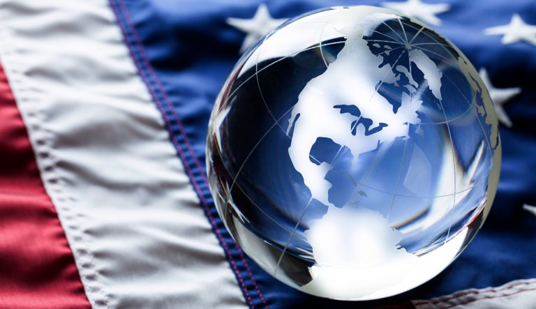 A glass globe sits on an American flag.