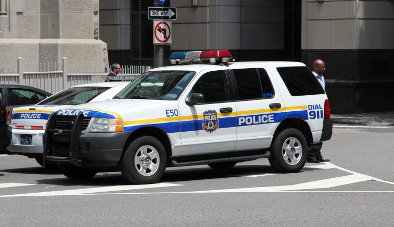 Philadelphia - June 11, 2013: A person walks by a Philadelphia Police Ford Explorer.
