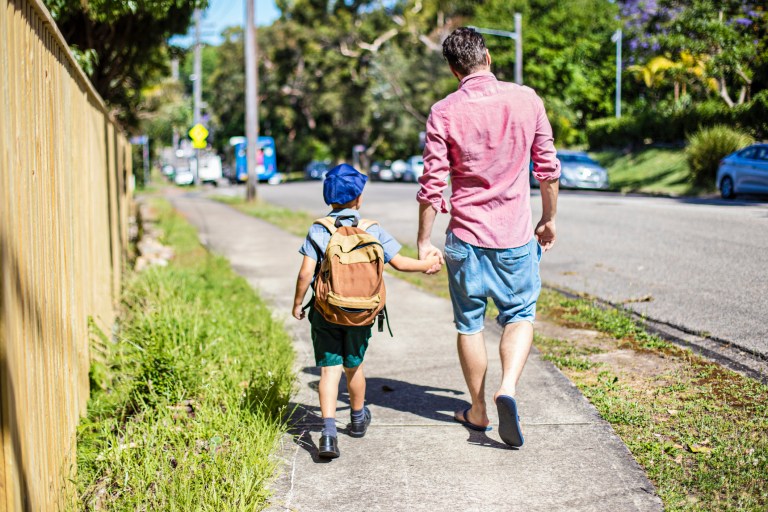 A father taking his son to school.