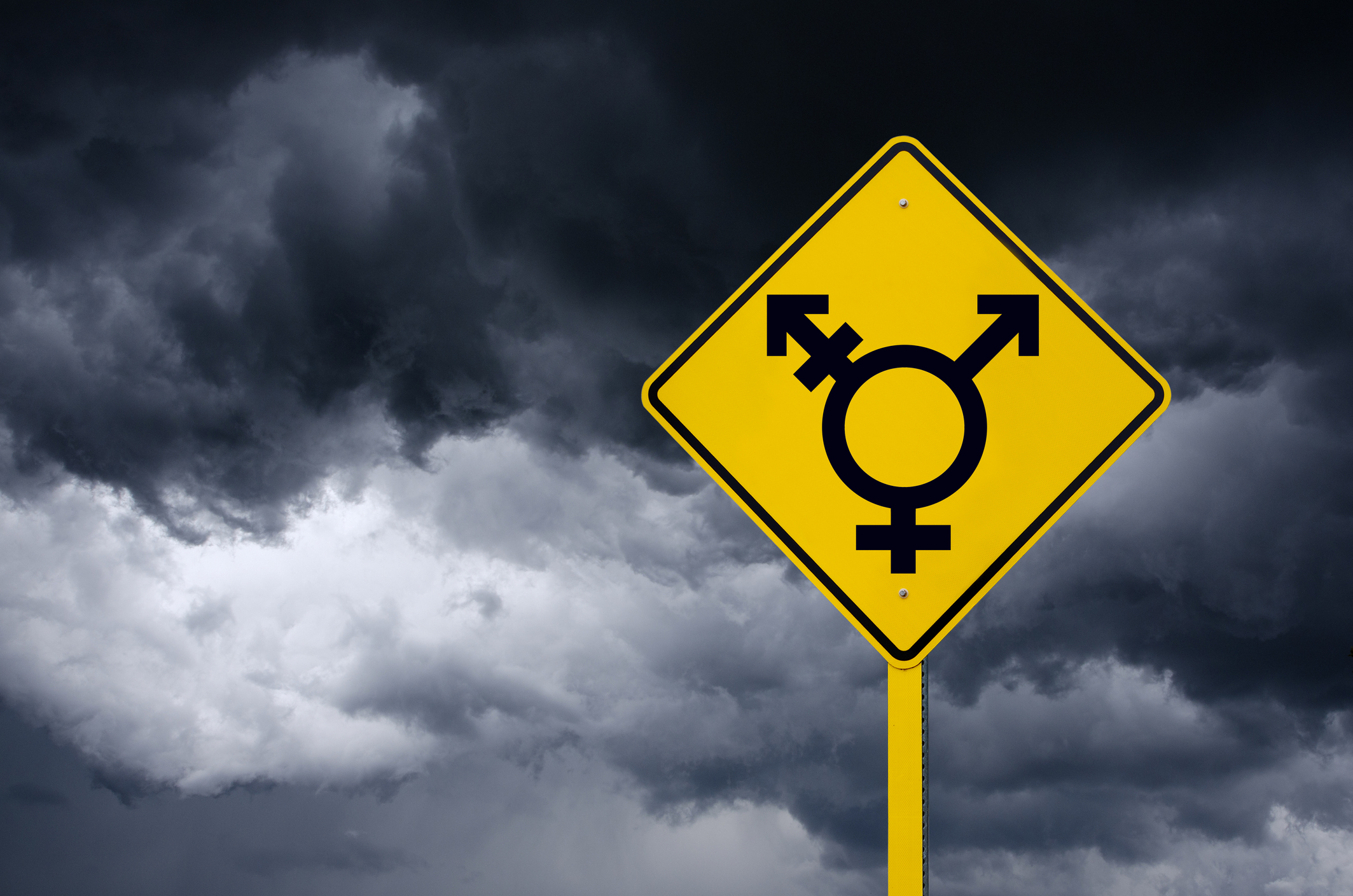 Road Sign with LGBT icon in Front of Storm Clouds