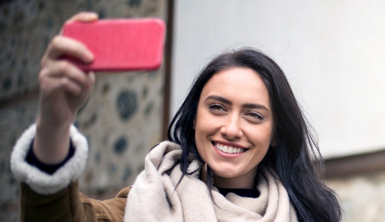 A woman takes a selfie.