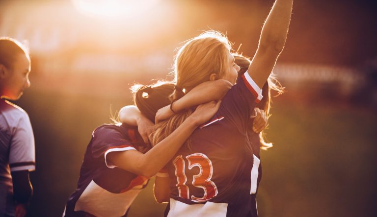 Soccer players celebrating on a field.