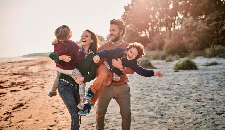 Close up of a happy family enjoying time on the beach.