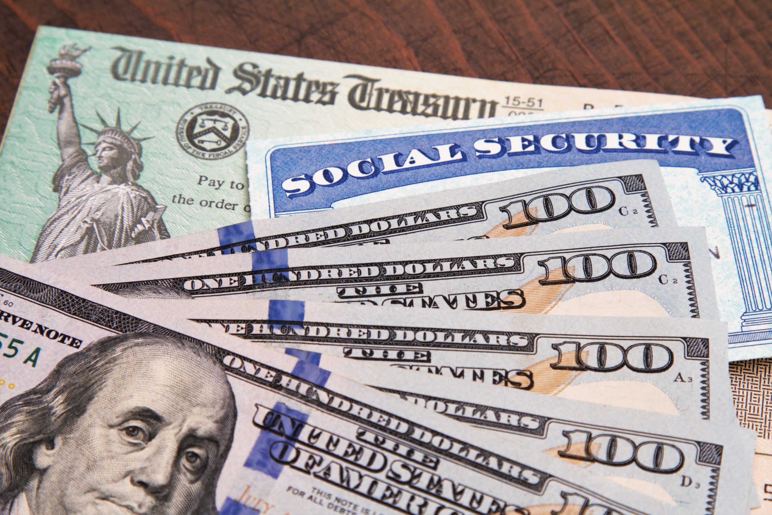 Money: closeup of USA currency with government treasury check and social security card