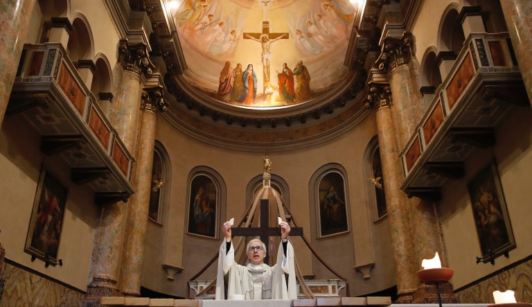 FILE - In this April 2, 2020 file photo, Don Angelo Riva celebrates a mass in an empty church in Carenno, Italy. The circle of contagion around the Italian priest couldnât have been tighter, the pain of watching those near him fall to the virus no more of a spiritual assault. Within two weeks of sitting with his parents and a fellow priest at lunch, the Rev. Angelo Riva was grieving the deaths of both his father and the colleague who assisted him at three mountain parishes above Lake Como. As Easter approached, Riva prepared for his mother to die, too. The new coronavirus causes mild or moderate symptoms for most people, but for some, especially older adults and people with existing health problems, it can cause more severe illness or death.