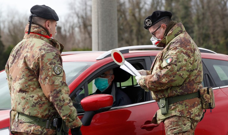 Italian Army soldiers check transit to and from the cordoned areas in Turano Lodigiano, Italy, Wednesday, Feb. 26, 2020. 