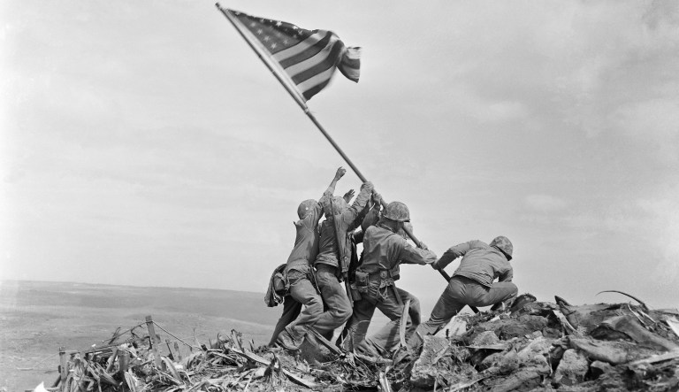 In this Feb 23, 1945 file photo, U.S. Marines of the 28th Regiment, 5th Division, raise the American flag atop Mt. Suribachi, Iwo Jima, Japan. The Marine Corps has corrected the identify of another of the men who were photographed raising the American flag at Iwo Jima during World War II. The Marines said Thursday that after questions were raised by private historians who studied photos and films, it determined that Cpl. Harold P. Keller was among the six men who raised the flag. The Marines say Pfc. Rene Gagnon had helped in the effort but for decades was mistakenly identified by the Marines as one of the flag-raisers.