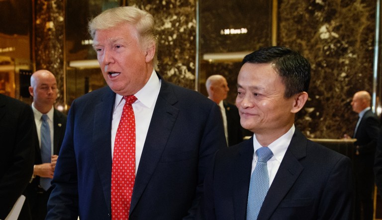 President-elect Donald Trump stands with Alibaba Executive Chairman Jack Ma as he speaks with reporters after a meeting at Trump Tower in New York, Monday, Jan. 9, 2017.