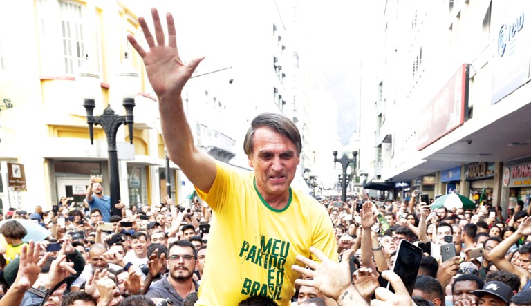 Presidential candidate Jair Bolsonaro is taken on the shoulders of a supporter moments before being stabbed during a campaign rally in Juiz de Fora, Brazil, Thursday, Aug. 6, 2018.