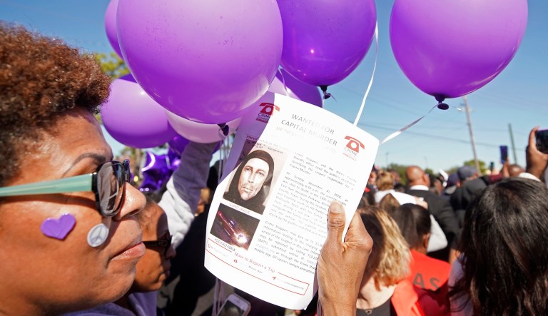 Donna Thomas holds a flyer about the shooting suspect as she attends a community rally for seven-year-old Jazmine Barnes on Saturday, Jan. 5, 2019 in Houston.   Barnes was killed  when a driver shot into the car she and her family were driving in last Sunday.