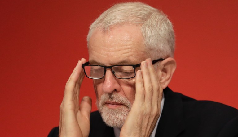 Jeremy Corbyn, Leader of Britain's opposition Labour Party listens on stage during the Labour Party Conference at the Brighton Centre in Brighton, England, Monday, Sept. 23, 2019.