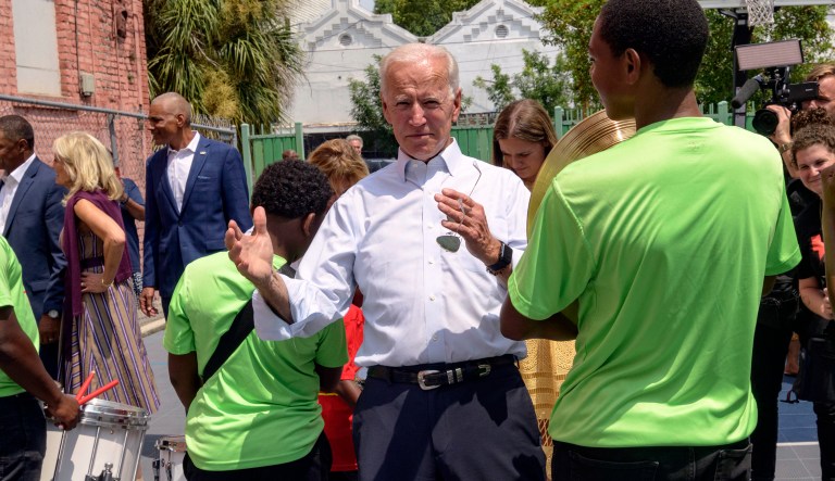 Democratic presidential candidate former Vice President Joe Biden speaks to kids as he tours the Youth Empowerment Project that targets at risk youth and young people with the drum line in New Orleans, Tuesday, July 23, 2019. 