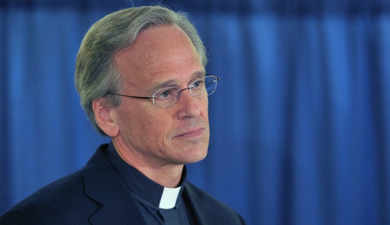 Rev. John I. Jenkins, C.S.C. the University's President, left,  talks about the academic scandal Friday Aug. 15, 2014 in South Bend, Ind. Notre Dame says it is investigating "suspected academic dishonesty" involving several students, including four members of the football team who are being held out of practice. 