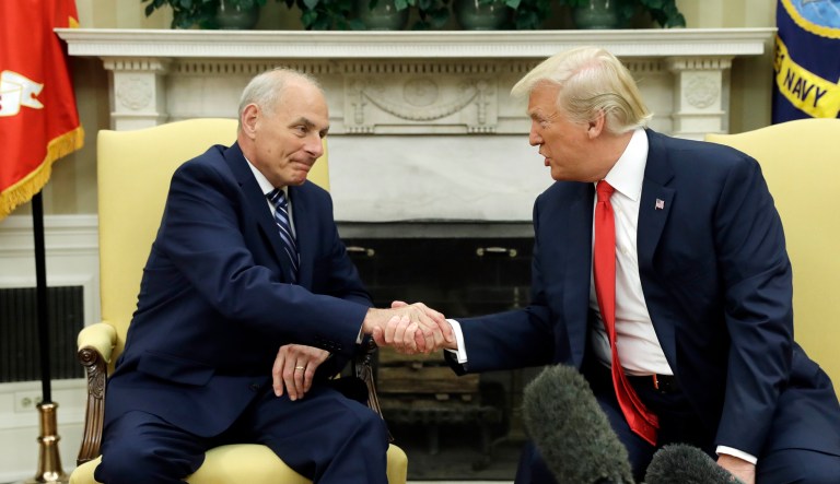 White House chief of staff John Kelly shakes hands with President Trump after being privately sworn in during a ceremony in the Oval Office in Washington.