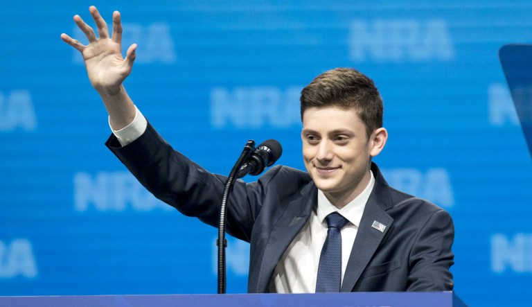 Kyle Kashuv, a student from Stoneman Douglas High School, waves as he arrives to speak at the National Rifle Association Institute for Legislative Action (NRA-ILA) Leadership Forum during the NRA annual meeting in Dallas, Texas, U.S., on Friday, May 4, 2018. PresidentÂ Donald TrumpÂ delivered a strong sign of support for the National Rifle Association at its annual meeting on Friday, as gun-rights advocates regroup in the wake of the mass shooting at a Florida high school.