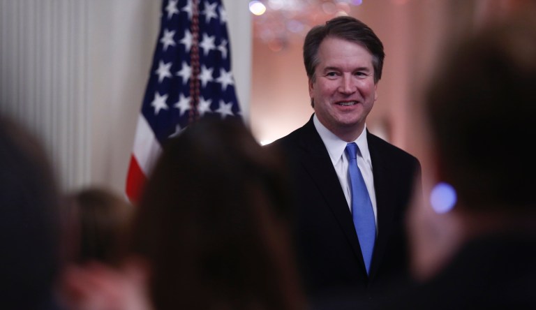 Brett Kavanaugh, associate justice of the U.S. Supreme Court, smiles as U.S. President Donald Trump, not pictured, speaks during a ceremonial swearing-in event in the East Room of the White House in Washington, D.C., U.S., on Monday, Oct. 8, 2018. 