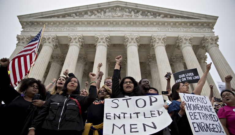 Demonstrators opposed to Supreme Court Associate Justice Brett Kavanaugh chant on the steps of the court in Washington, D.C., U.S., on Saturday, Oct. 6, 2018. Kavanaugh was confirmed to the U.S. Supreme Court after one of the most ferocious confirmation battles in history, overcoming allegations of school-age sexual assault and claims by Democrats that he was dishonest in Senate hearings.