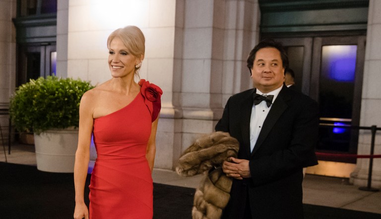 In this Thursday, Jan. 19, 2017 file photo, President-elect Donald Trump adviser Kellyanne Conway, center, accompanied by her husband, George, speaks with members of the media as they arrive for a dinner at Union Station in Washington, the day before Trump's inauguration.