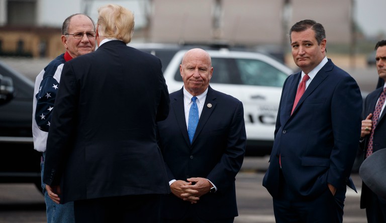 Rep. Kevin Brady, R-Texas, center, and Sen. Ted Cruz, R-Texas, greet President Donald Trump after he got off Air Force One at Ellington Field Joint Reserve Base, Monday, Oct. 22, 2018, in Houston.