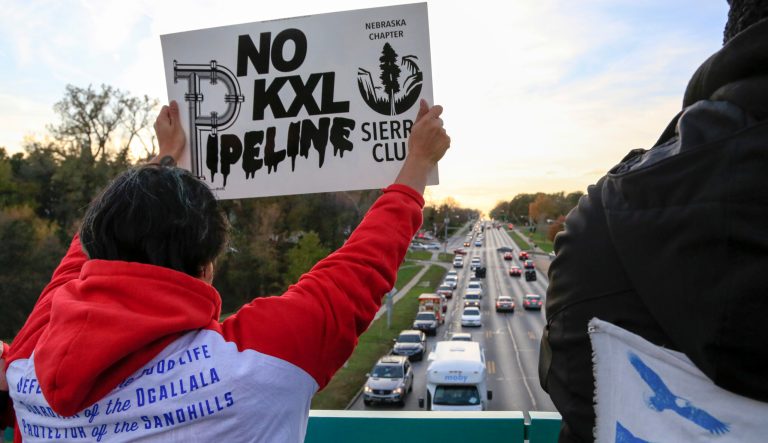Opponents of the Keystone XL pipeline demonstrate on the Dodge Street pedestrian bridge during rush hour in Omaha, Neb., Wednesday, Nov. 1, 2017. The Nebraska Public Service Commission has until Nov. 23 to decide whether to approve or reject a proposed state route for the Keystone XL pipeline. 