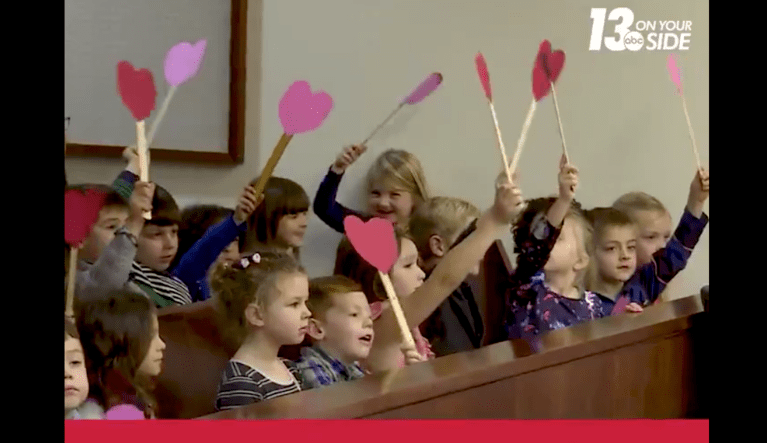 A young boy's entire kindergarten class attends his adoption hearing as he officially becomes part of a new family. 