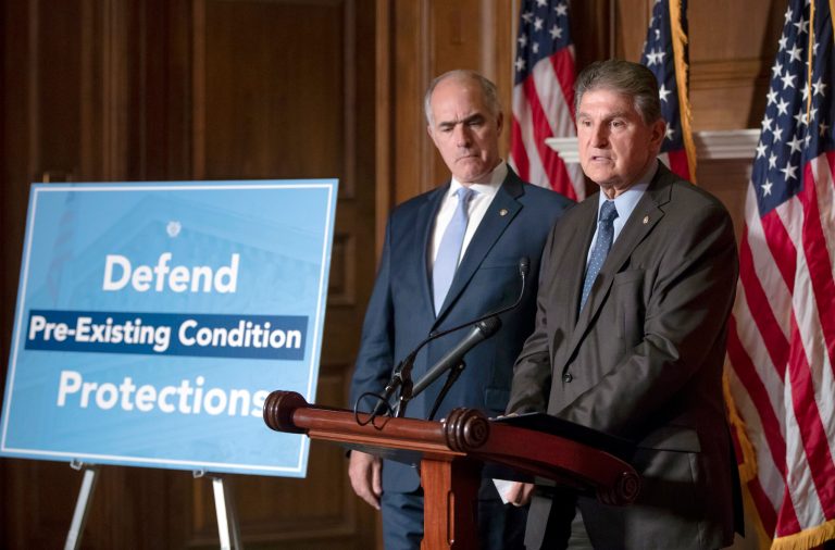 Sen. Bob Casey, D-Pa., left, and Sen. Joe Manchin, D-W.Va., talk about their efforts to defend health insurance protections for people with pre-existing conditions, on Capitol Hill in Washington, Thursday, July 19, 2018. (AP Photo/J. Scott Applewhite)
