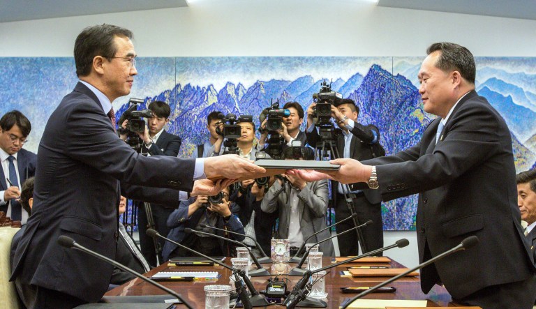 South Korean Unification Minister Cho Myoung-gyon, left, and North Korean delegation head Ri Son Gwon exchange documents signed an agreement during their meeting inside the Peace House at the southern side of Panmunjom in the Demilitarized Zone Friday, June 1, 2018. North and South Korea on Friday resumed senior-level peace talks Seoul sees as an important step in building trust with Pyongyang amid a U.S.-led diplomatic push to persuade the North to give up its nuclear weapons.