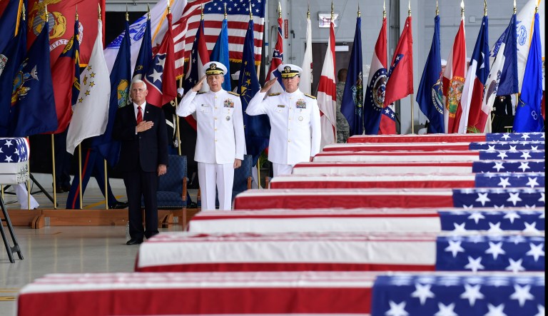 Vice President Mike Pence, left, Commander of U.S. Indo-Pacific Command Adm. Phil Davidson, center, and Rear Adm. Jon Kreitz, deputy director of the POW/MIA Accounting Agency, attend at a ceremony marking the arrival of the remains believed to be of American service members who fell in the Korean War at Joint Base Pearl Harbor-Hickam, Hawaii, Wednesday, Aug. 1, 2018. North Korea handed over the remains last week.