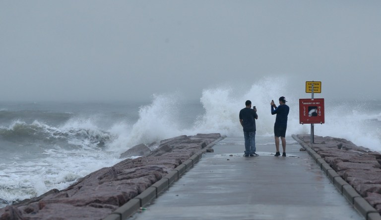 Josue Blanco, left, and Alex Mendez photograph waves generated by Hurricane Laura as they crash into the rock groin at 37th Street in Galveston, Texas on Wednesday, Aug. 26, 2020. Forecasters say Laura is rapidly intensifying and will become a âcatastrophicâ Category 4 hurricane before landfall. It's churning toward Texas and Louisiana, gathering wind and water that swirls over much of the Gulf of Mexico.