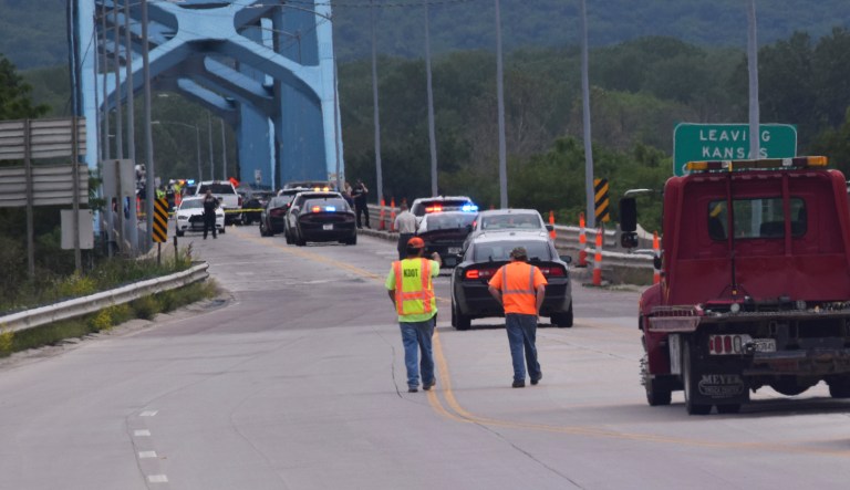 Authorities gather on Centennial Bridge after a shooting Wednesday, May 27, 2020, near Leavenworth, Kan. A Fort Leavenworth soldier is being credited with saving lives after he stopped a person who was randomly shooting on the bridge that connects Kansas and Missouri.