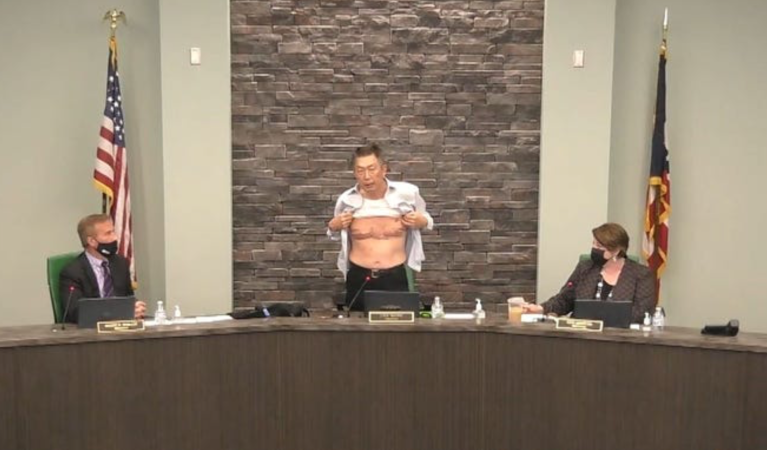 Asian American veteran and town trustee bears chest scars to make a point about discrimination