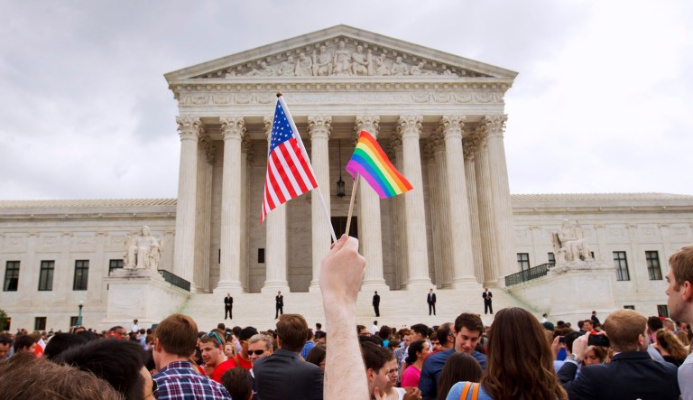 In this Friday, June 26, 2015 file photo, a crowd celebrates outside of the Supreme Court in Washington after the court declared that same-sex couples have a right to marry anywhere in the U.S.
