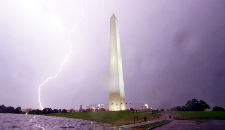 A lightning bolt hits the ground behind the Washington Monument as a severe thunderstorm passes through Washington, D.C., late Wednesday, June 29, 1984.