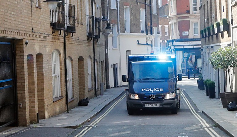 An armored police vehicle, believed to contain Salih Khater, drives into the car park at Westminster Magistrates court in London, Monday, Aug. 20, 2018.  The Metropolitan Police force said 29-year-old Salih Khater who drove a car to collide with several people before crashing outside Britain's Parliament, faces charges including attempted murder.
