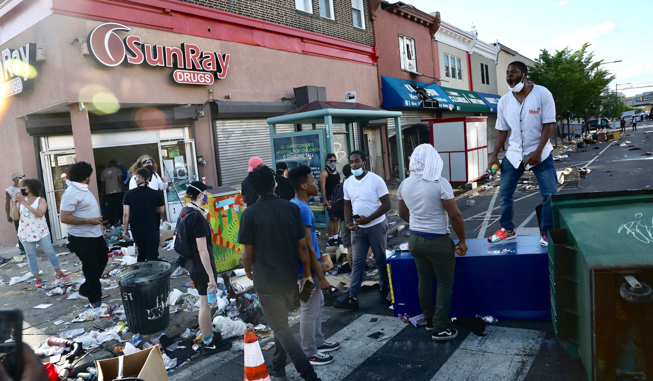 ‘Protecting our neighborhoods’: Philadelphia residents armed with AR-15s and baseball bats watch over businesses