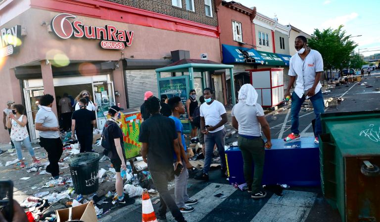 ‘Protecting our neighborhoods’: Philadelphia residents armed with AR-15s and baseball bats watch over businesses